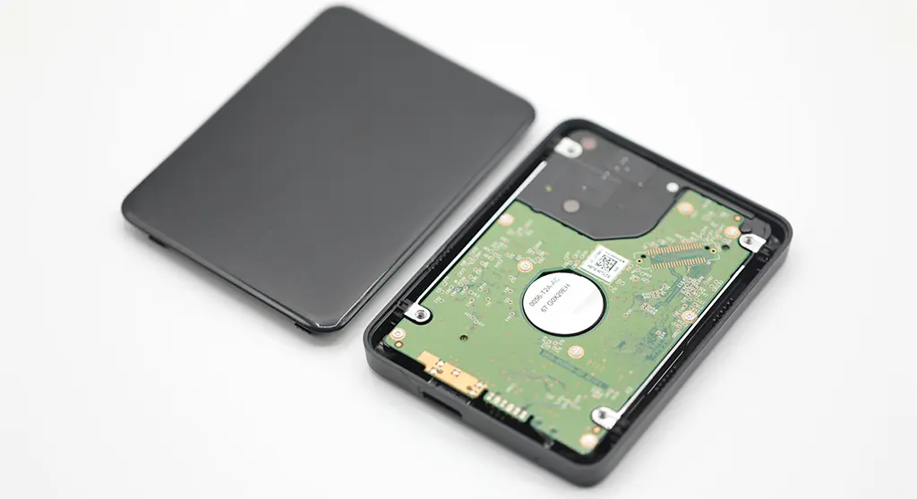 Opened external hard drive enclosure showing internal circuit board and drive components