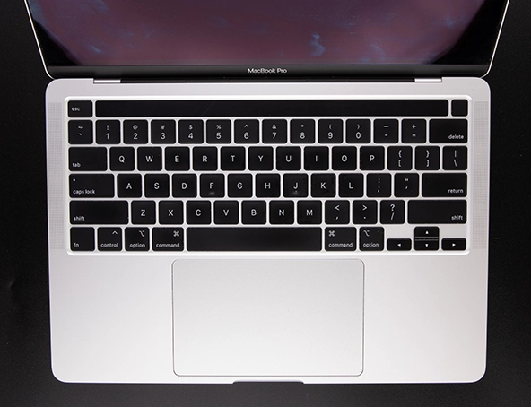 Top view of an open MacBook Pro showing the keyboard, touchpad, and part of the display.