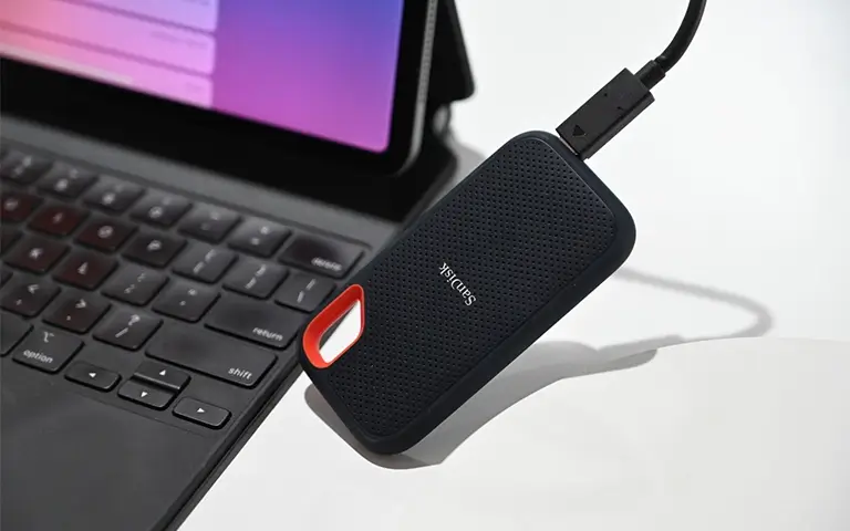 SanDisk external SSD connected to a tablet with keyboard