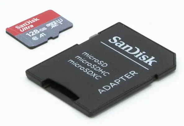 SanDisk 128GB microSD card alongside a full-size SD card adapter for microSD, microSDHC, and microSDXC formats.
