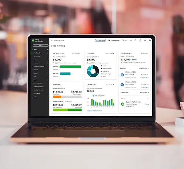 Open laptop displaying the QuickBooks accounting dashboard, showing financial data such as profit & loss, expenses, cash flow, and account balances.