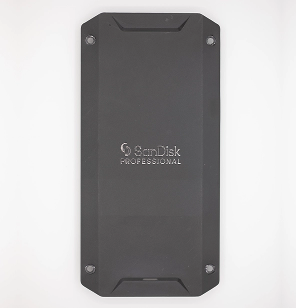 Top-down view of a SanDisk Professional external solid-state drive (SSD) in a rugged black enclosure, designed for high-performance portable data storage.